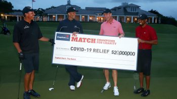 Tiger Woods and former NFL player Peyton Manning celebrate defeating Phil Mickelson and NFL player Tom Brady of the Tampa Bay Buccaneers on the 18th green during The Match: Champions For Charity