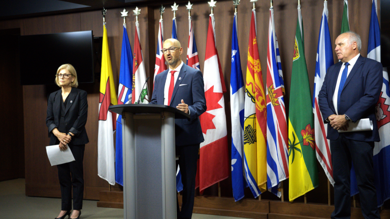 Laurence Applebaum standing at podium